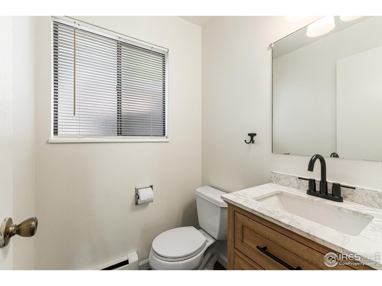 705 East Drake Road, Unit 35 Fort Collins, CO 80525 - Photo 11 of 34 a bathroom with a sink a toilet and mirror