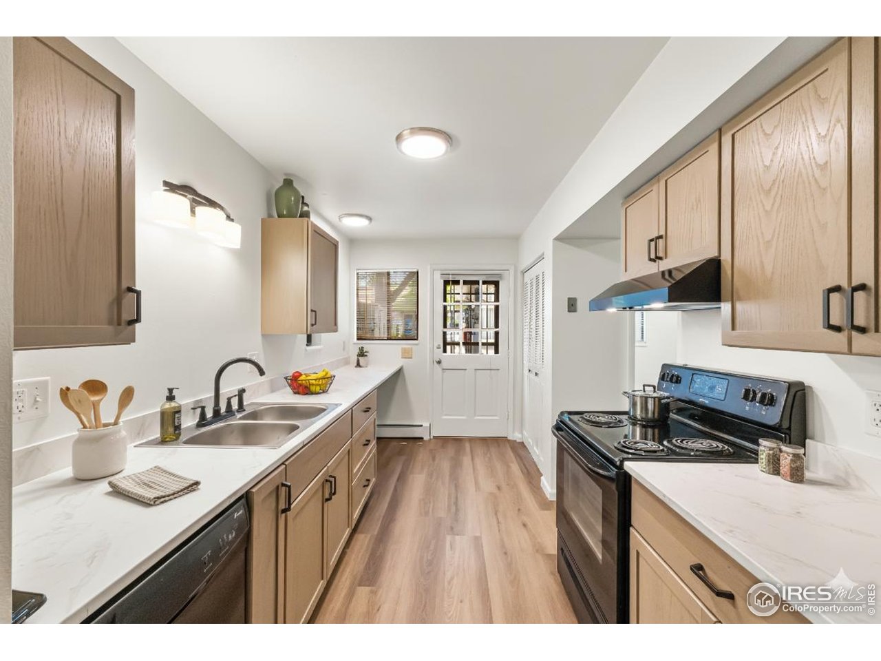 705 East Drake Road, Unit 35 Fort Collins, CO 80525 - Photo 2 of 34 a kitchen with sink a stove and cabinets