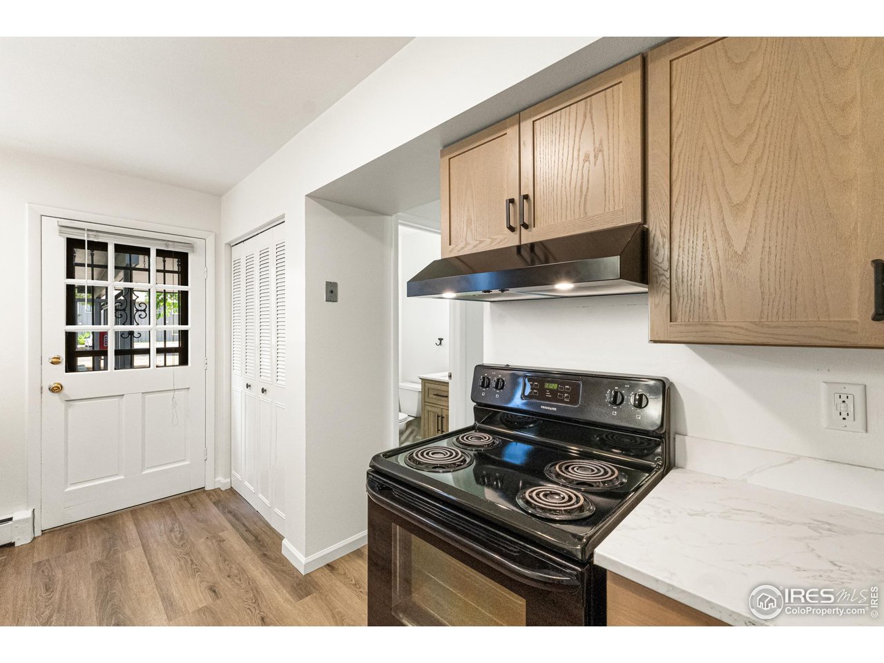 705 East Drake Road, Unit 35 Fort Collins, CO 80525 - Photo 5 of 34 a kitchen with granite countertop a stove and a wooden cabinets