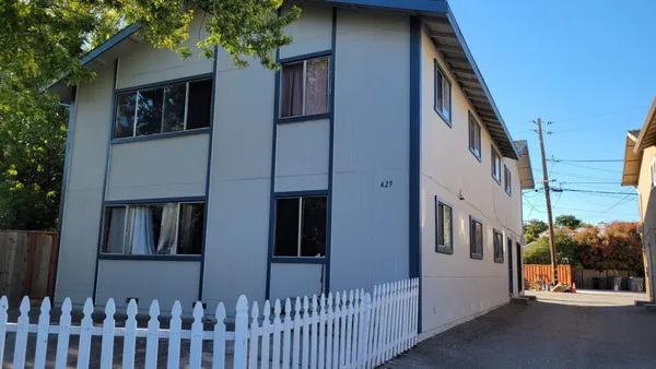 a view of a house with a small yard