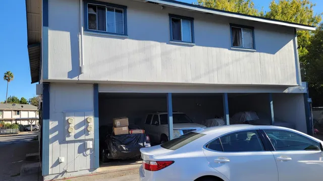 a front view of a house with parking space