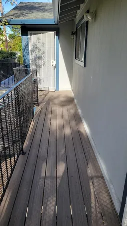 a view of balcony with wooden floor