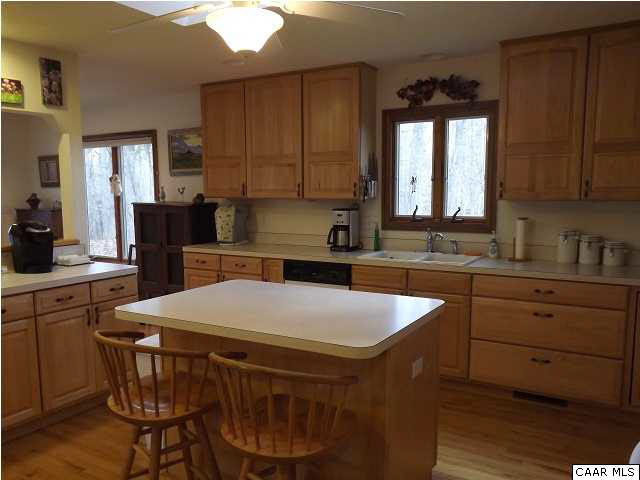 61 Dogleg Road Palmyra, VA 22963 - Photo 12 of 39 a kitchen with a table chairs sink and cabinets