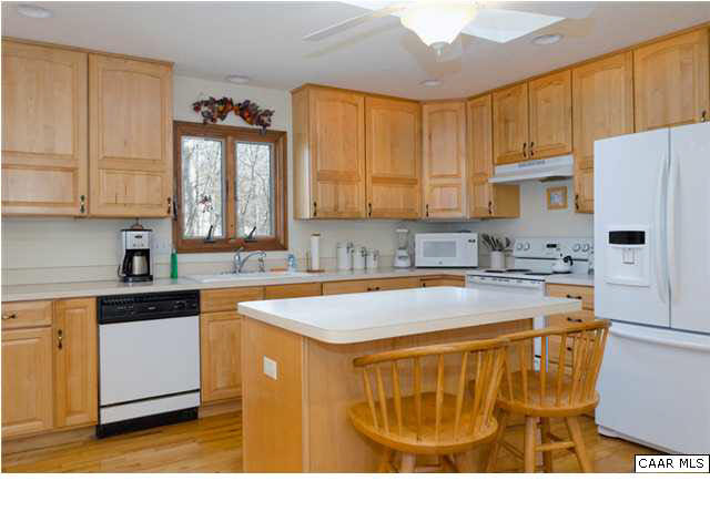 61 Dogleg Road Palmyra, VA 22963 - Photo 13 of 39 a kitchen with kitchen island granite countertop a sink a counter top space and cabinets