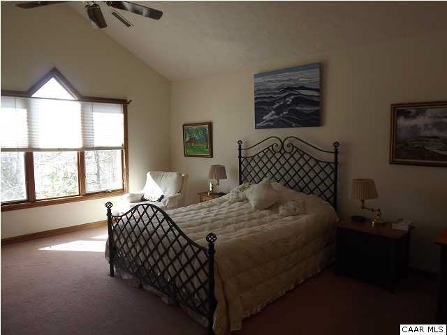 61 Dogleg Road Palmyra, VA 22963 - Photo 20 of 39 a bedroom with bed and a large window