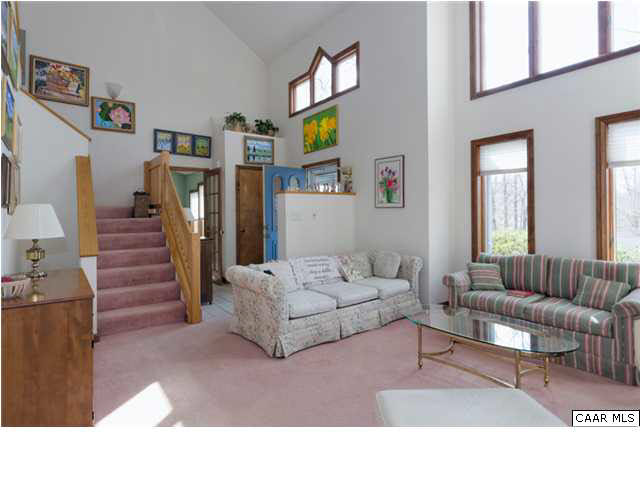 61 Dogleg Road Palmyra, VA 22963 - Photo 10 of 39 a living room with furniture and a flat screen tv