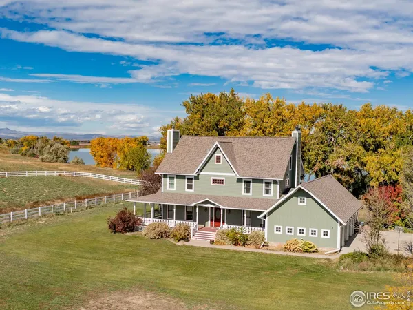 a view of house with yard and ocean view