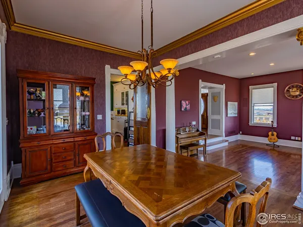 a kitchen with stainless steel appliances granite countertop a sink a stove and a wooden floors