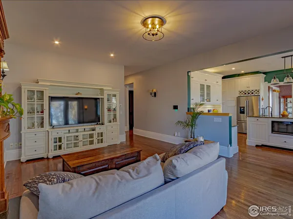 a view of a hallway with wooden floor and front door