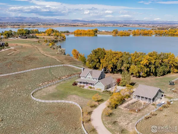 an aerial view of a house with a swimming pool an outdoor seating
