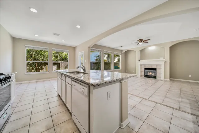 a kitchen with granite countertop a sink and a stove