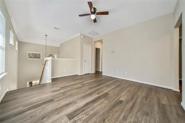 a view of a room with wooden floor and white walls