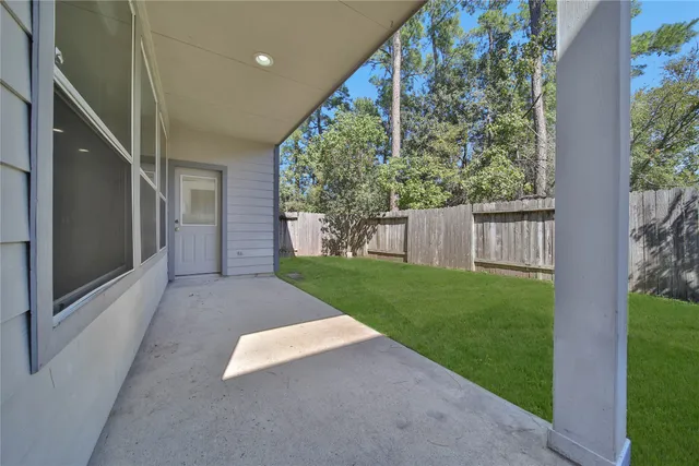 a view of a house with backyard and porch