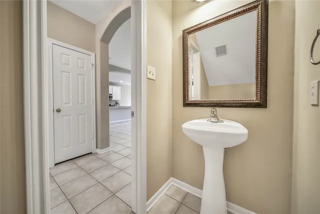 a bathroom with a sink and mirror with toilet