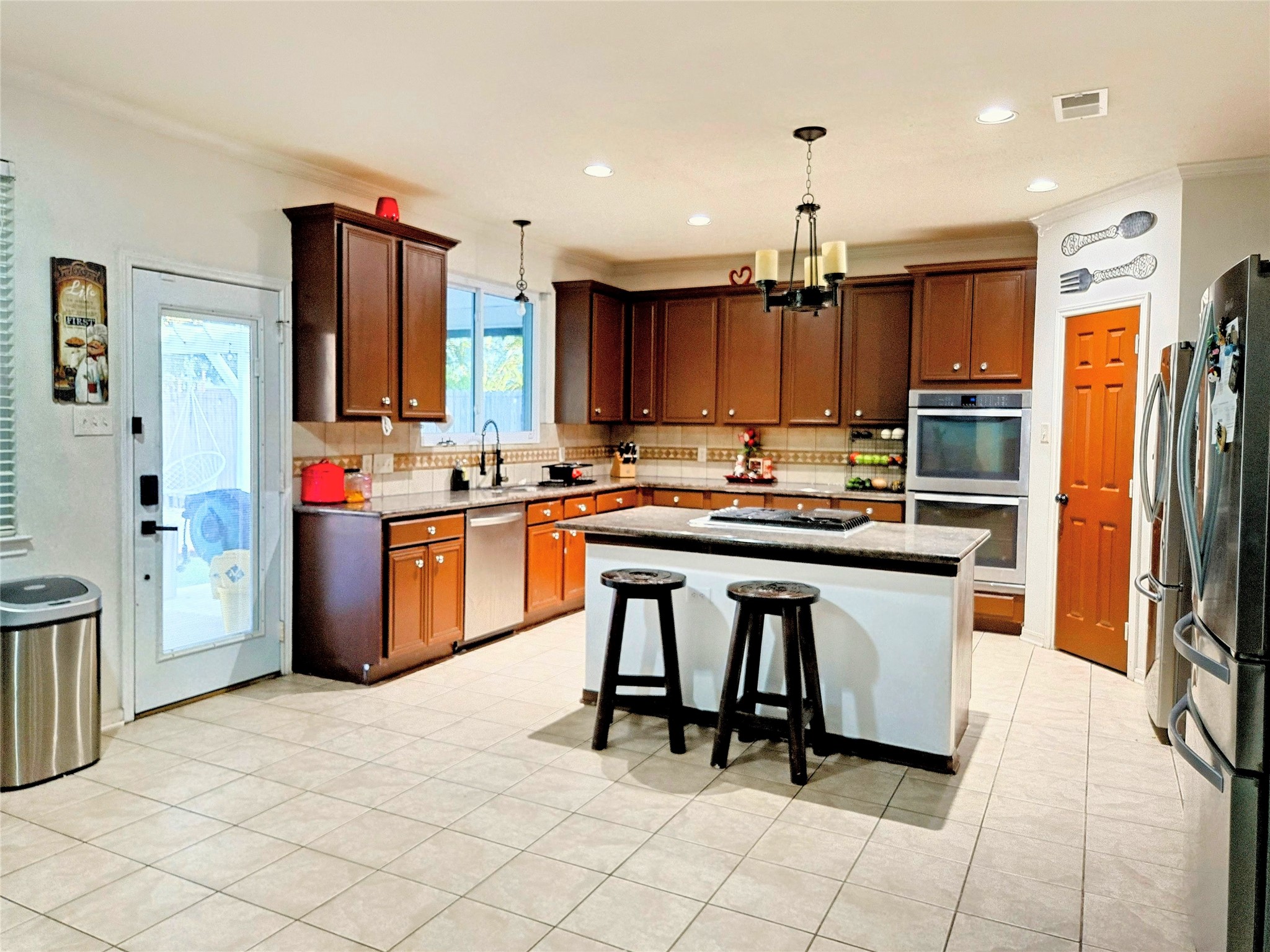 9211 Memorial Grove Drive Spring, TX 77379 - Photo 38 of 38 a kitchen with kitchen island granite countertop a sink cabinets and stainless steel appliances