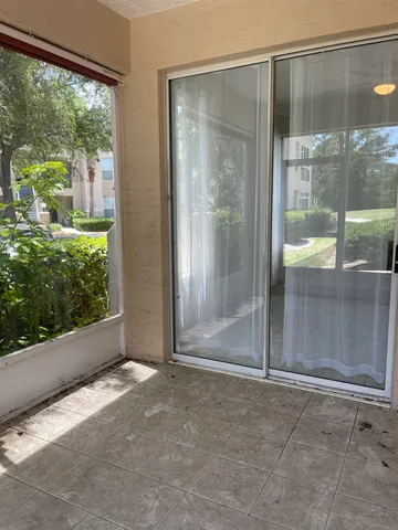 a view of a glass door with a yard