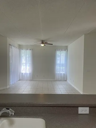 a living room with a couch and chandelier