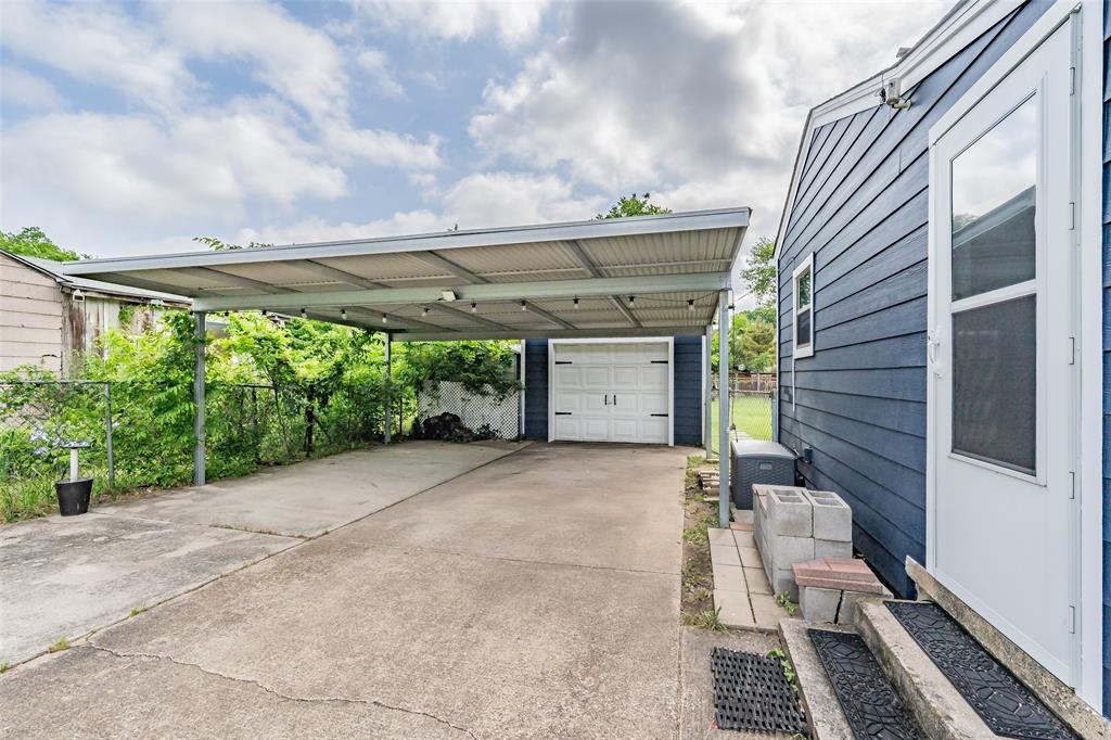 1802 Keneipp Road Carrollton, TX 75006 - Photo 18 of 22 The property includes a carport covering a concrete driveway, leading to a garage with a white door