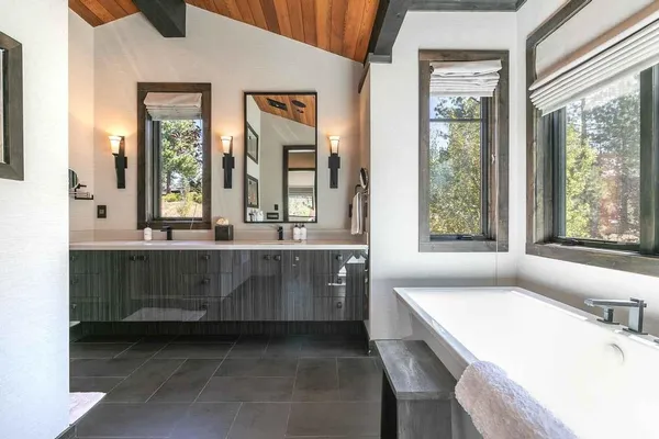 a bathroom with double vanity sink and a mirror