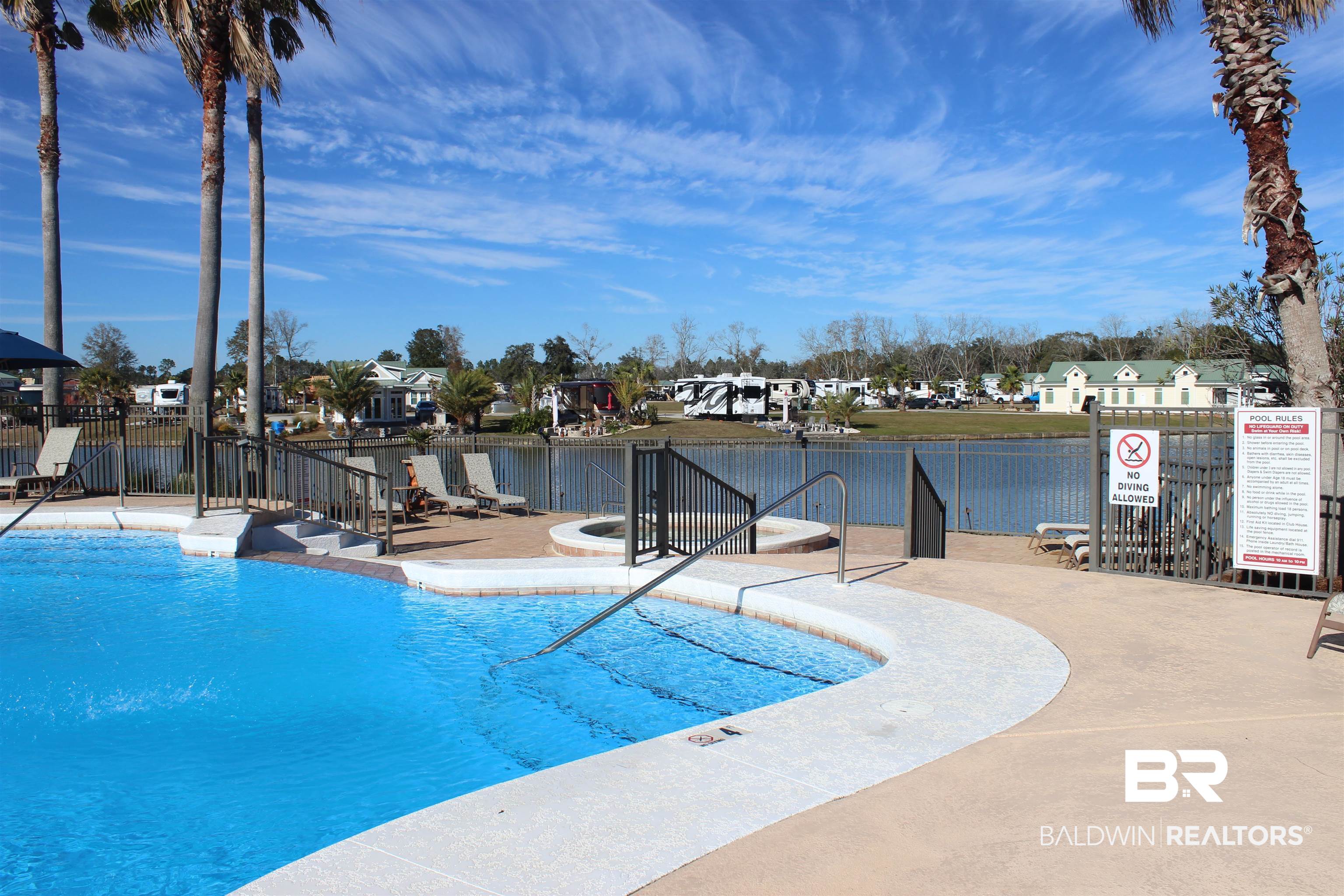 12489 Gateway Drive Elberta, AL 36530 - Photo 28 of 55 Community pool featuring a residential view, a patio area, a water view, and fence