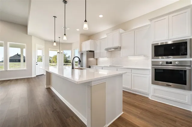 a large kitchen with stainless steel appliances kitchen island a large island in the center