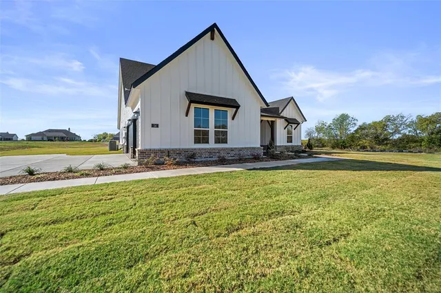 a view of a house with pool and a yard