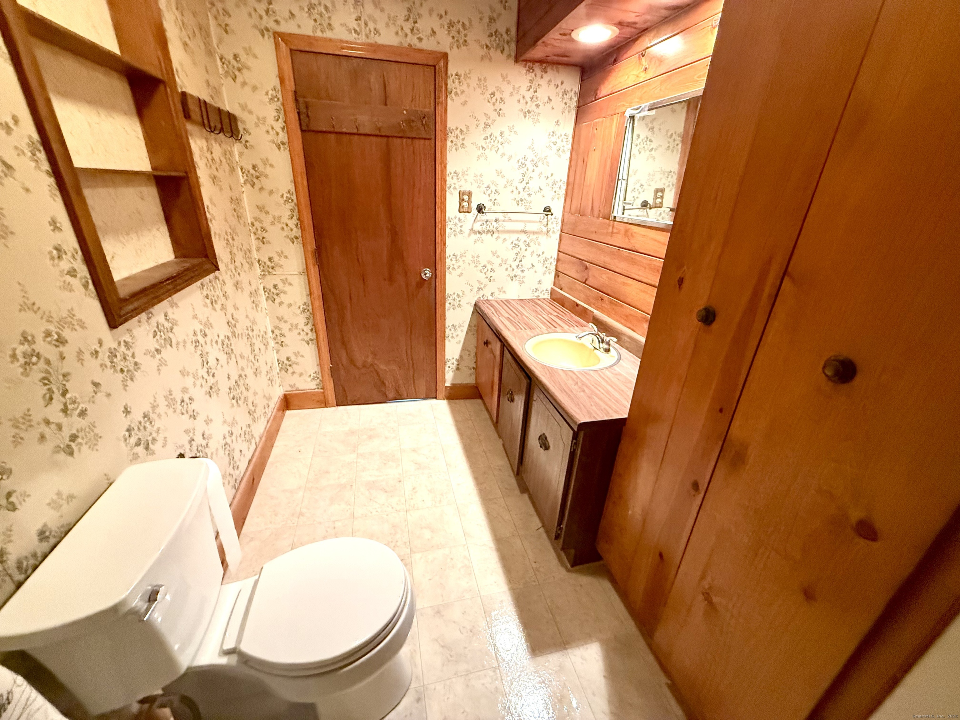 16 Naugatuck Avenue Shelton, CT 06484 - Photo 18 of 36 a bathroom with a sink and a mirror