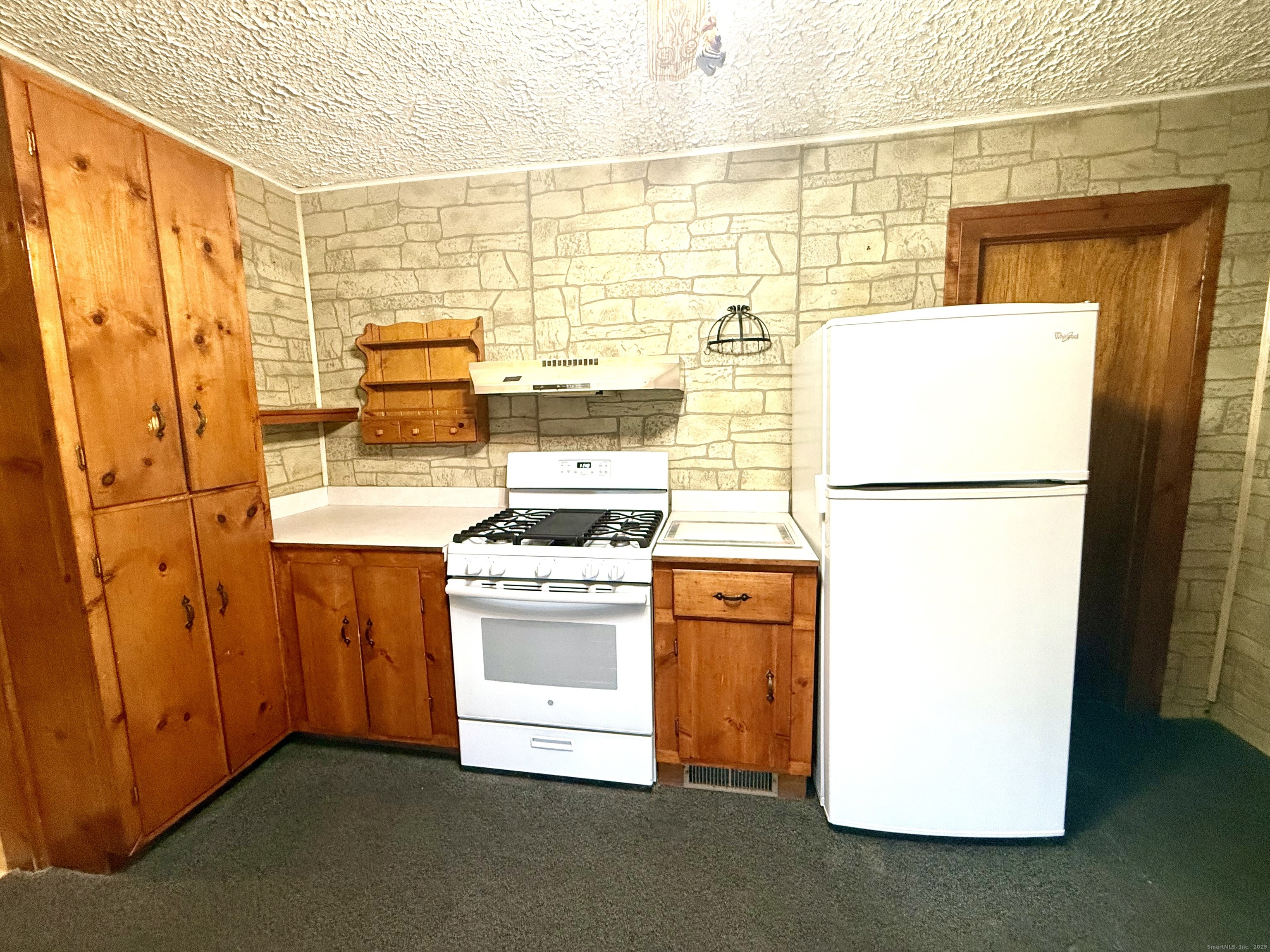 16 Naugatuck Avenue Shelton, CT 06484 - Photo 8 of 36 a kitchen with refrigerator and stove