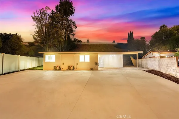 a view of a house with a yard and a garage