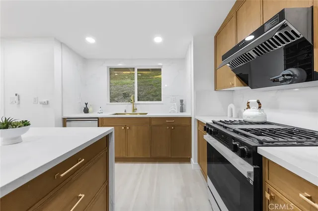 a kitchen with a stove a sink and a microwave