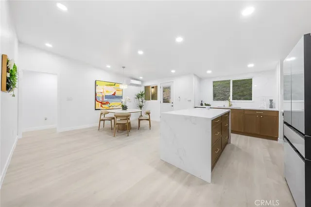 a living room with stainless steel appliances kitchen island furniture and a view of kitchen