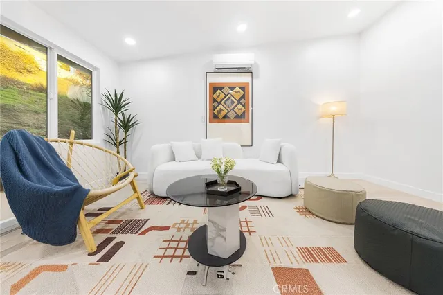 a living room with furniture and a large window