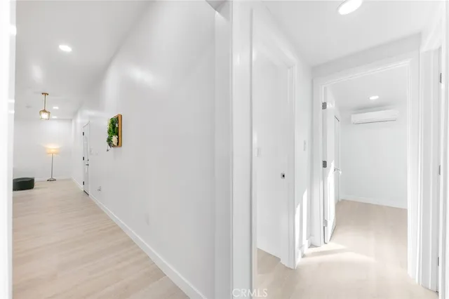 a view of a hallway with wooden floor