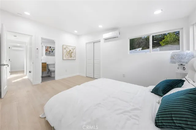 a bedroom with a bed and a flat screen tv