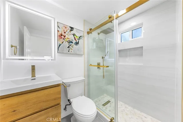 a bathroom with a granite countertop toilet a sink and bathtub