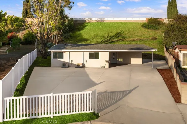 a view of a balcony with wooden floor and fence