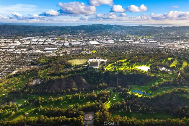 an aerial view of residential houses with outdoor space and swimming pool