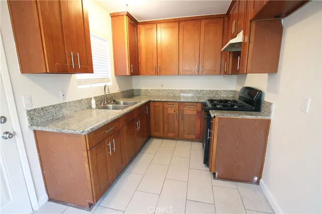 a kitchen with stainless steel appliances granite countertop a sink counter space and cabinets