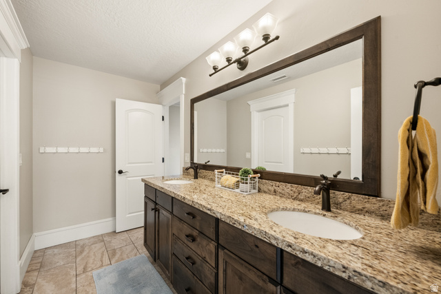 1205 North Elk Rdg Lane, Unit 202 Alpine, UT 84004 - Photo 60 of 88 Double vanity featuring a granite countertop, dual undermount sinks, and dark wood cabinetry
