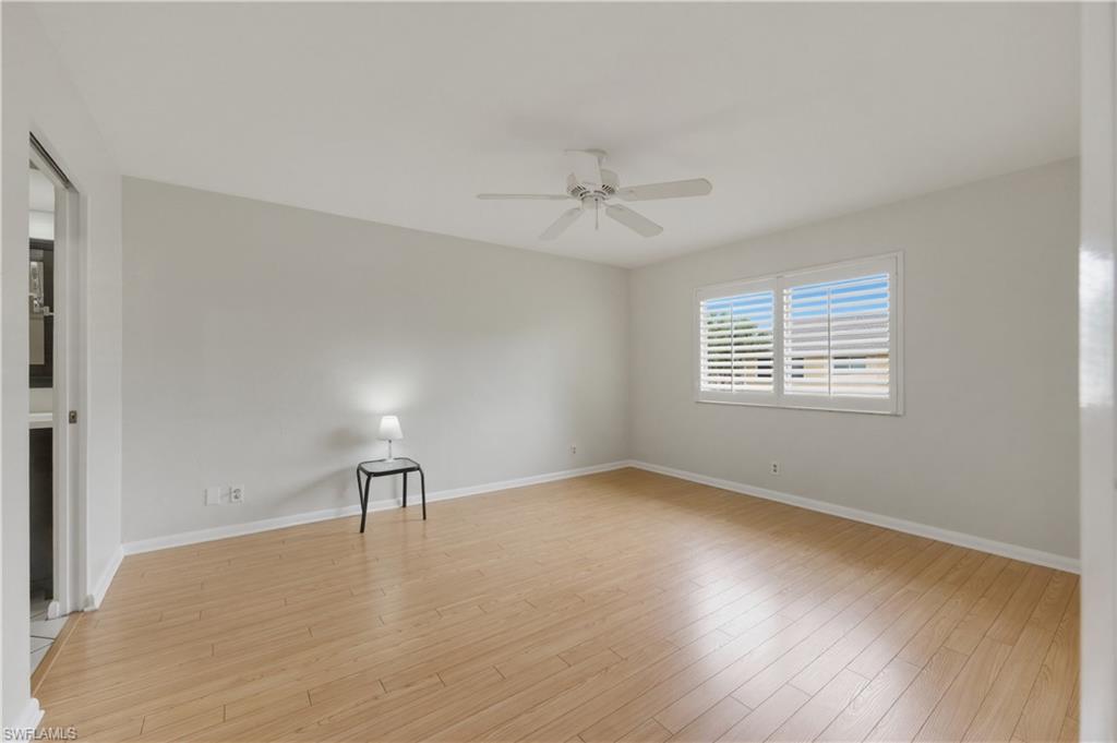 4031 Ice Castle Way, Unit 3306 Naples, FL 34112 - Photo 12 of 25 Master Bedroom with light wood-style flooring and ceiling fan