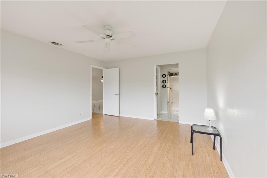 4031 Ice Castle Way, Unit 3306 Naples, FL 34112 - Photo 13 of 25 Master Bedroom with light wood-style flooring and ceiling fan