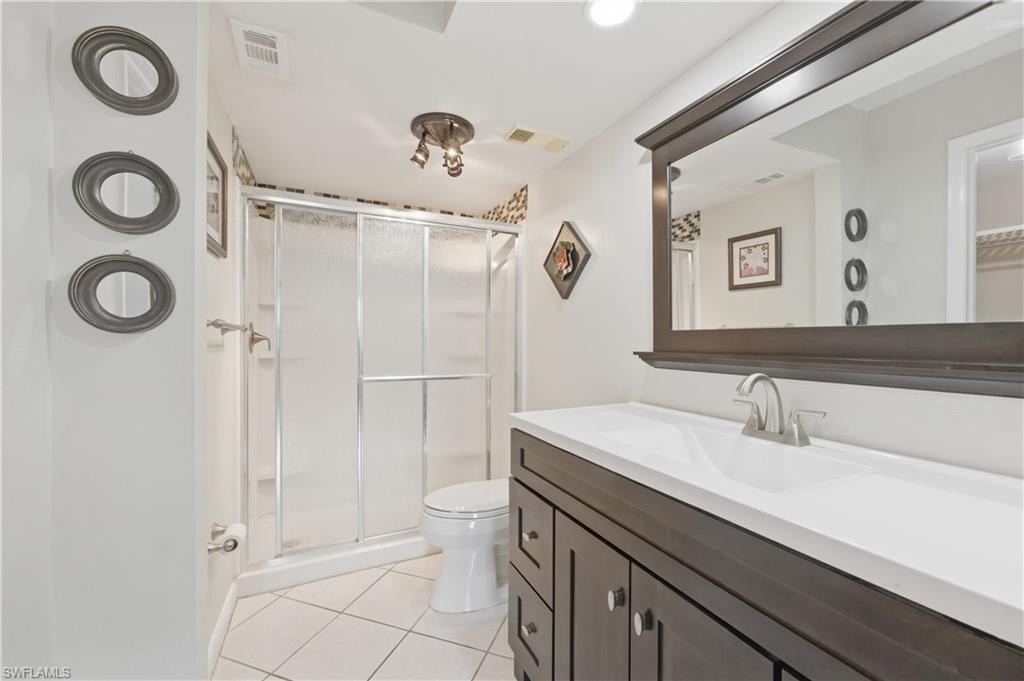 4031 Ice Castle Way, Unit 3306 Naples, FL 34112 - Photo 14 of 25 Master Bathroom with vanity, light tile patterned floors, and a shower stall