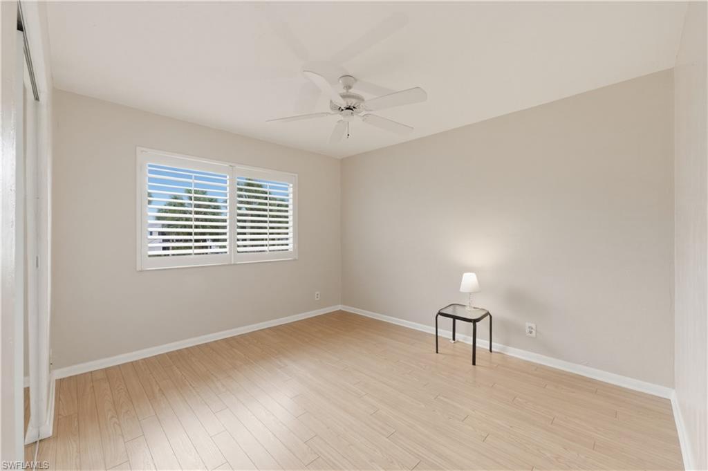 4031 Ice Castle Way, Unit 3306 Naples, FL 34112 - Photo 17 of 25 Spare Bedroom with light wood-style floors and a ceiling fan