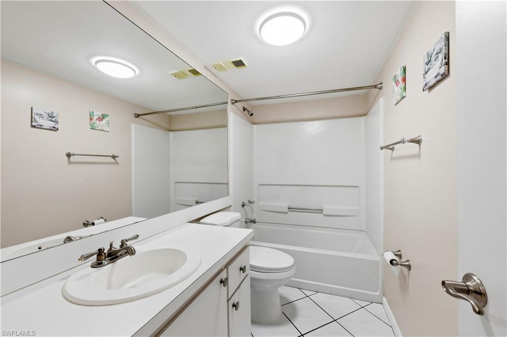 4031 Ice Castle Way, Unit 3306 Naples, FL 34112 - Photo 18 of 25 Guest Bathroom featuring vanity, bathtub / shower combination, and light tile patterned flooring