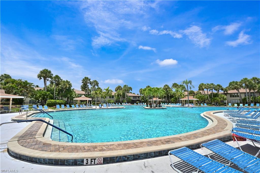 4031 Ice Castle Way, Unit 3306 Naples, FL 34112 - Photo 23 of 25 Community pool with a patio