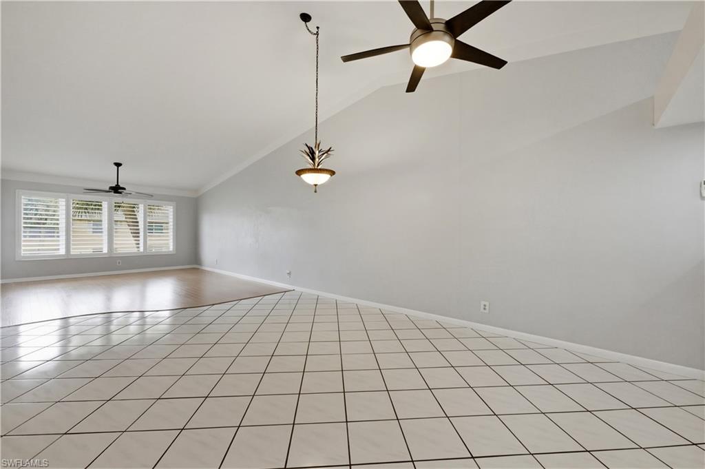 4031 Ice Castle Way, Unit 3306 Naples, FL 34112 - Photo 6 of 25 Great room featuring a ceiling fan, vaulted ceiling, and light tile patterned floors