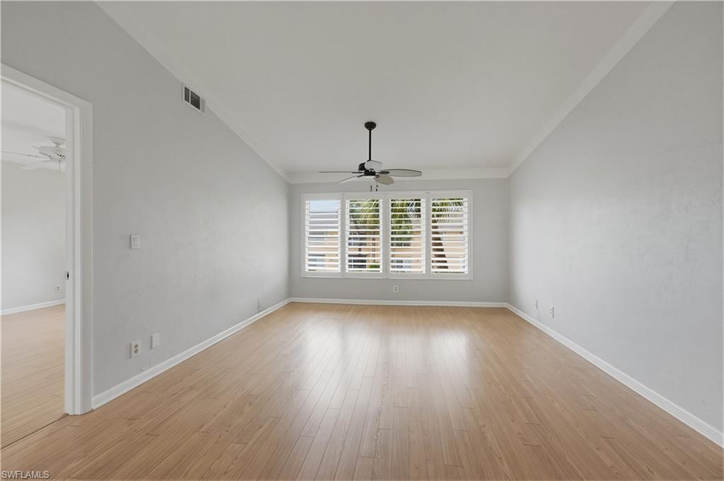 4031 Ice Castle Way, Unit 3306 Naples, FL 34112 - Photo 9 of 25 Living room with ceiling fan, light wood finished floors, and crown molding