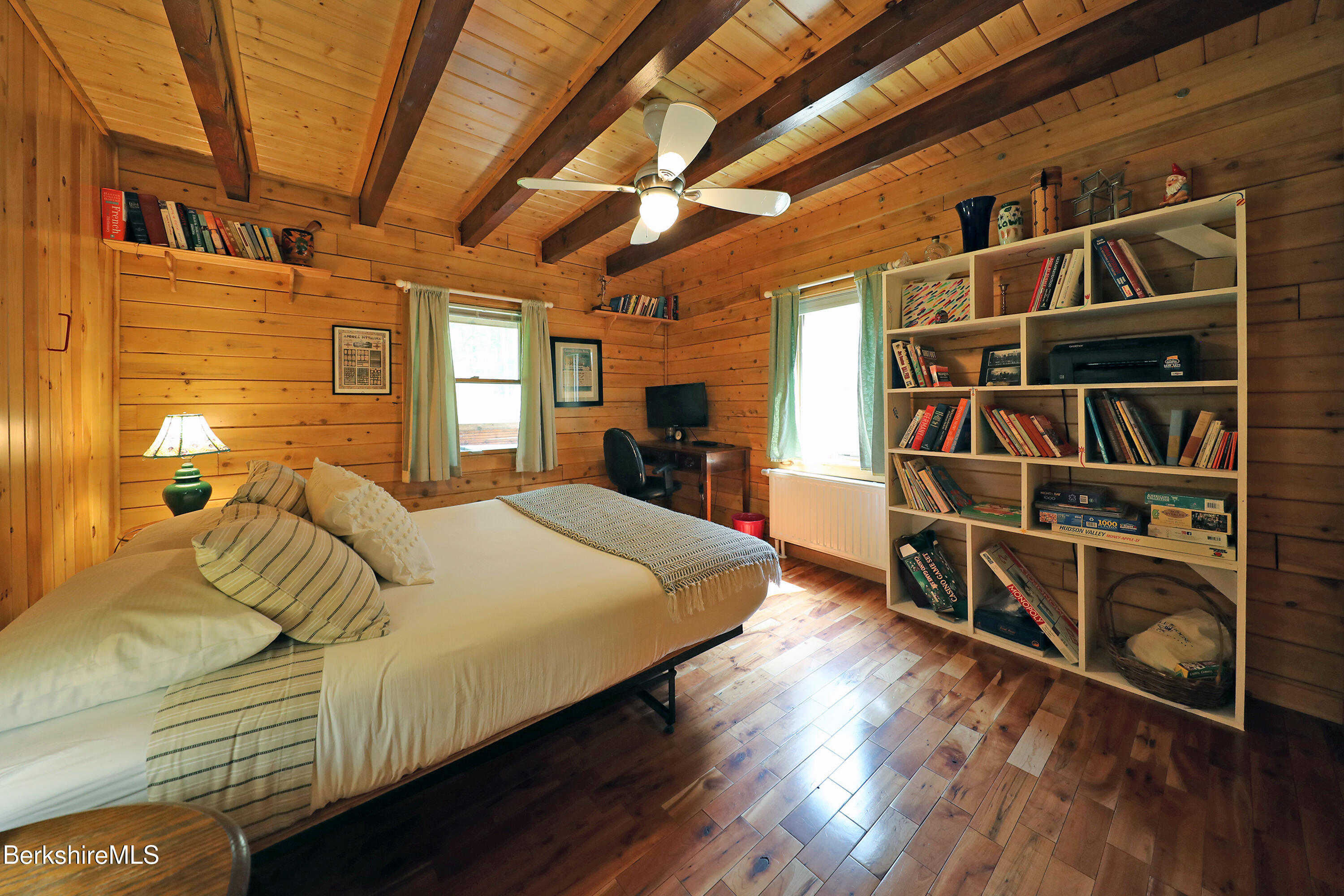 235 Algerie Road Becket, MA 01223 - Photo 15 of 43 a bed sitting in a bedroom next to a walk in closet