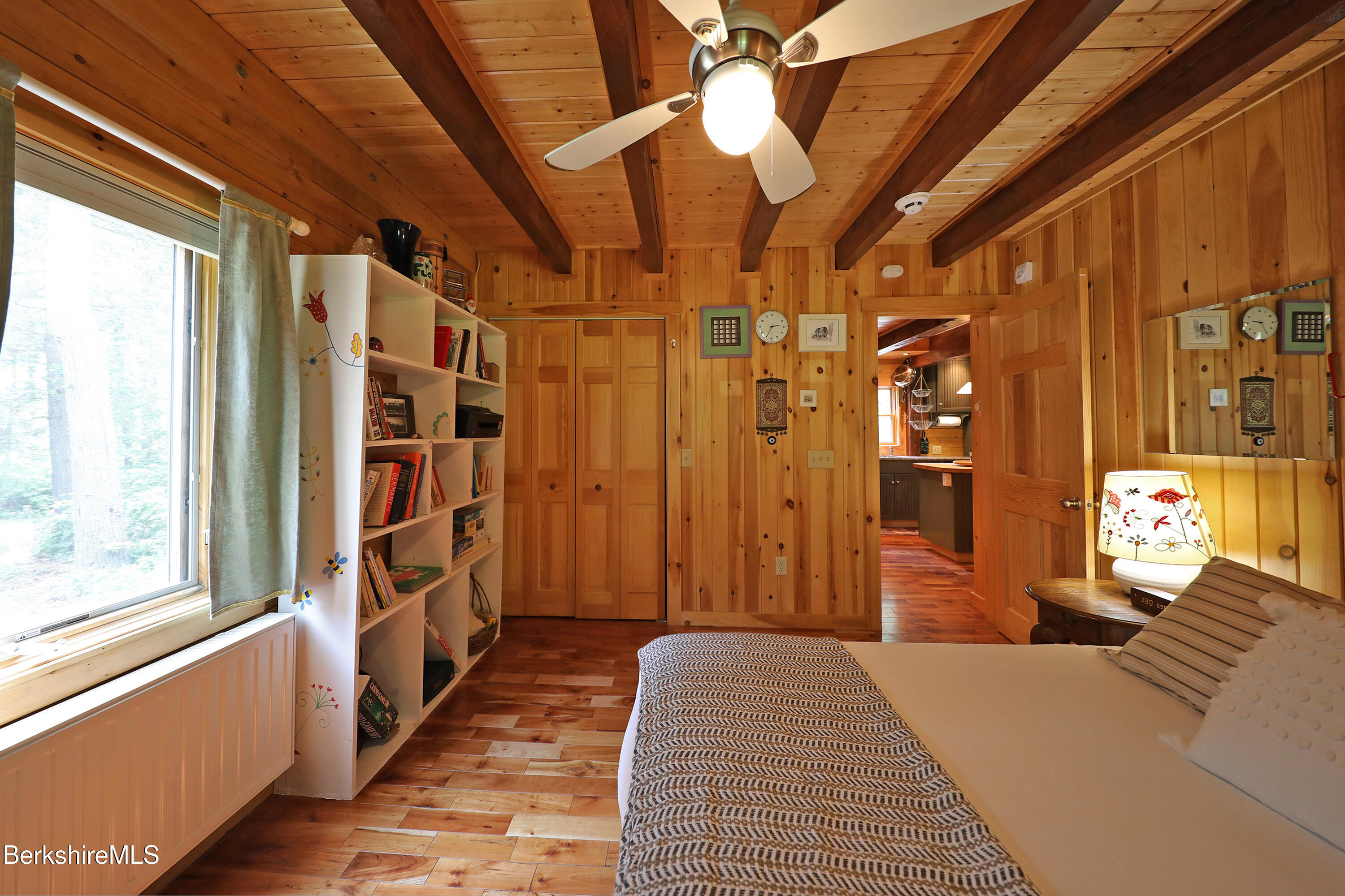 235 Algerie Road Becket, MA 01223 - Photo 16 of 43 a bedroom with a bed and a chandelier