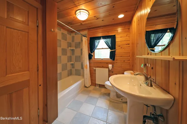 a bathroom with a sink a bathtub and a shower